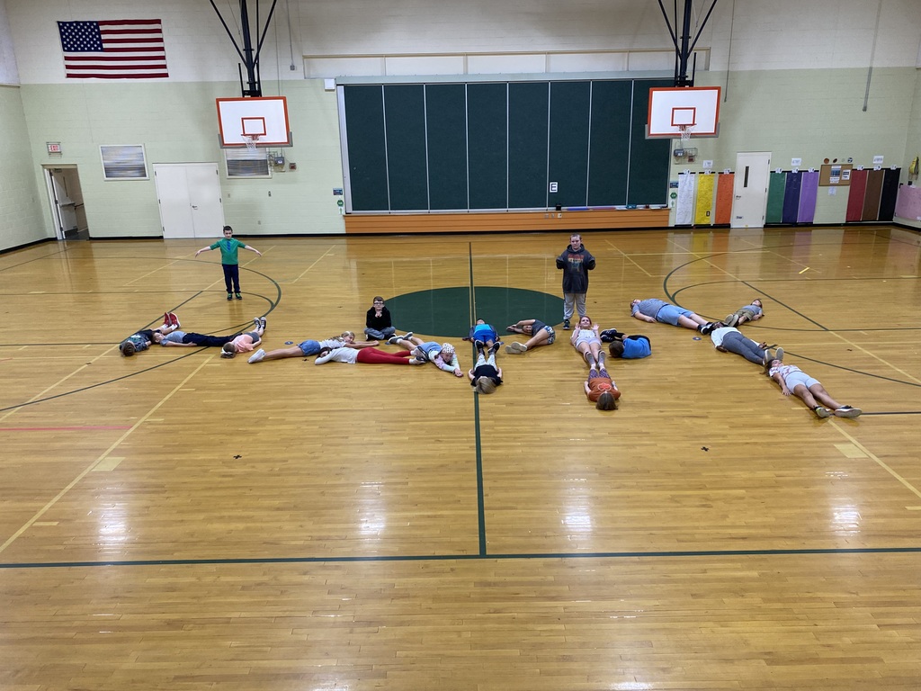 5th grade class spelling out happy on gym floor