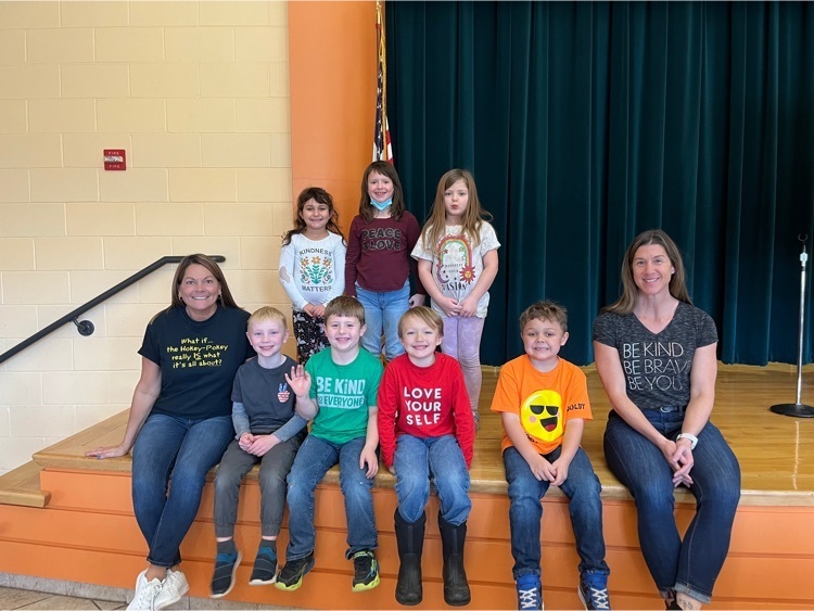 first graders and staff members wearing shirts with positive messages