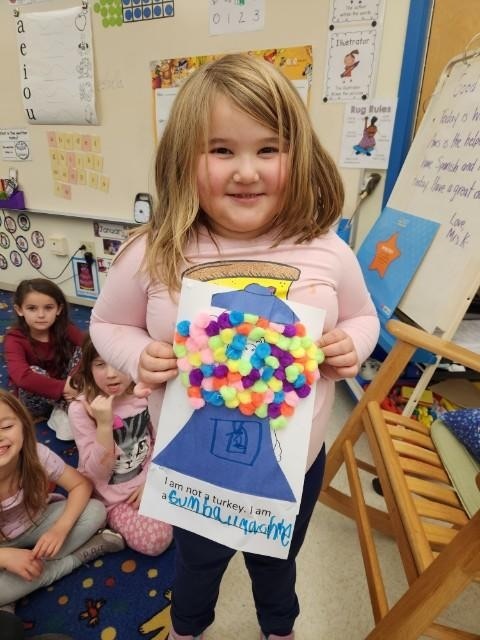 Kindergartener with turkey picture disguised as a gumball machine 