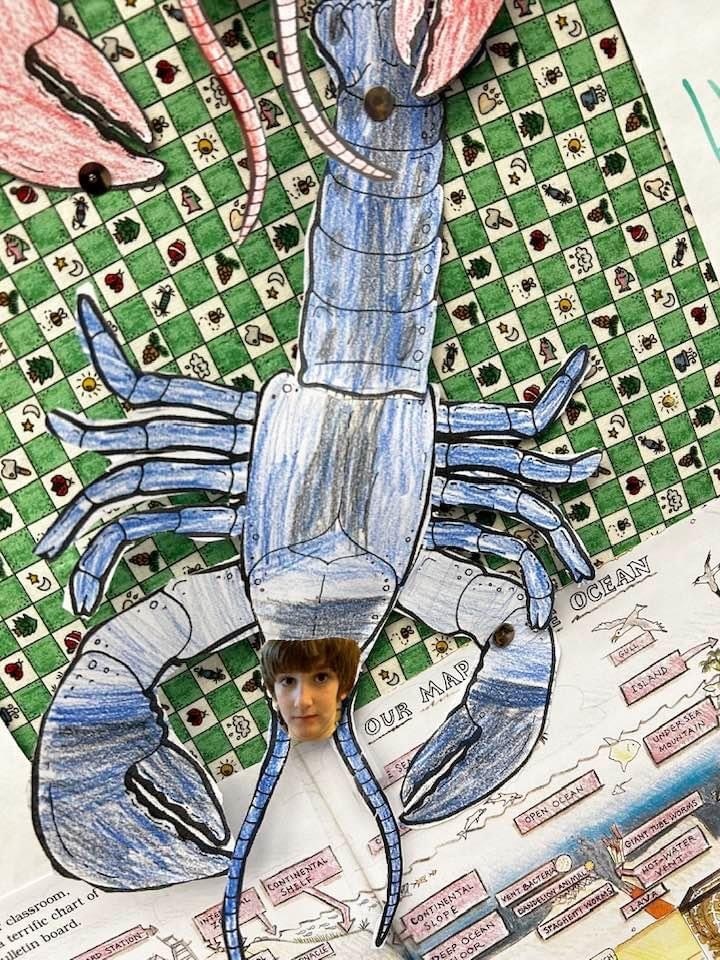 realistic lobster made of paper with students face glued on
