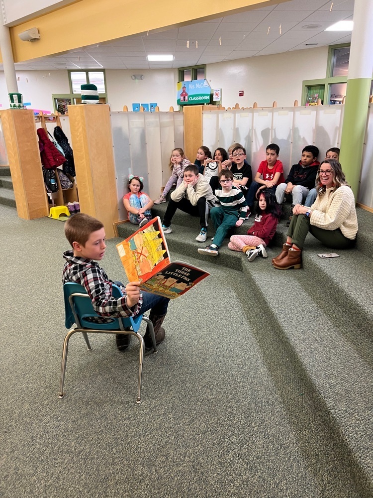 student reading to his classmates