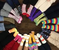 A circle of feet all wearing different socks